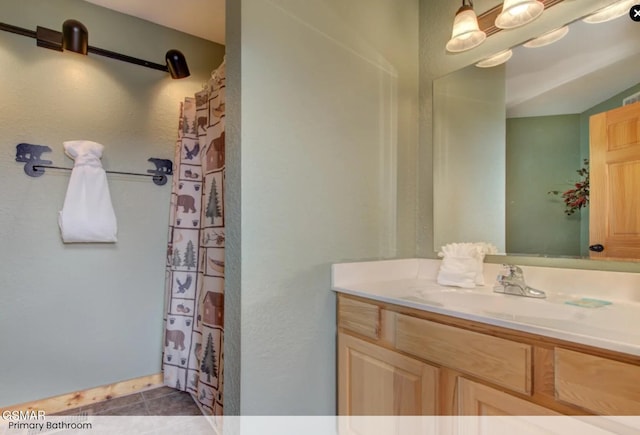 full bath featuring tile patterned floors, curtained shower, and vanity