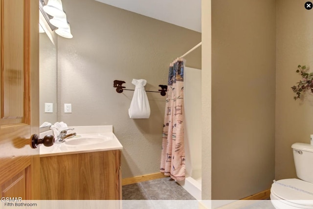 bathroom featuring a stall shower, vanity, toilet, and tile patterned flooring