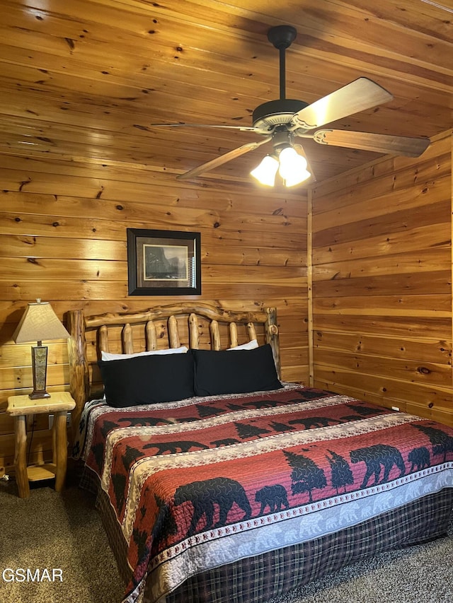 bedroom with carpet, wooden ceiling, wooden walls, and a ceiling fan