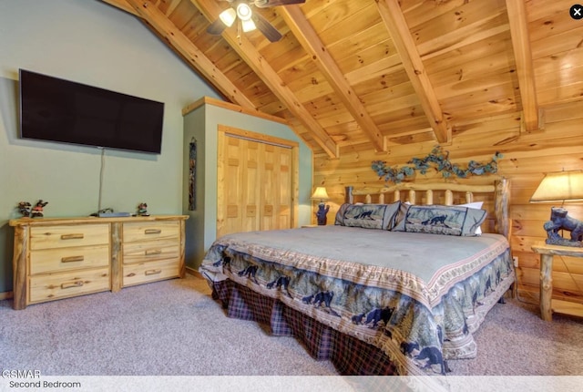 bedroom with wood ceiling, a closet, carpet flooring, and vaulted ceiling with beams