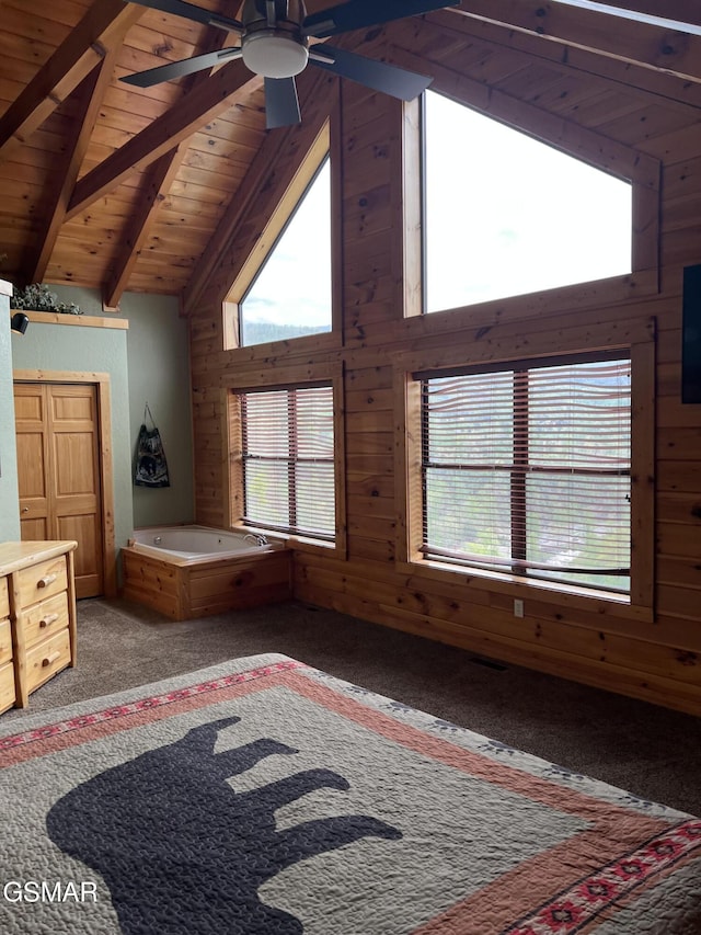 unfurnished bedroom with multiple windows, wood ceiling, wooden walls, and high vaulted ceiling