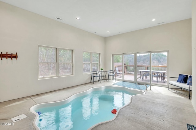 indoor pool featuring a jacuzzi