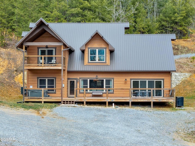 chalet / cabin with metal roof and a balcony