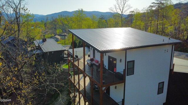1040 Old Cartertown Rd, Gatlinburg, TN 37738 - back of house at twilight featuring outdoor lounge area, a balcony, and a patio area