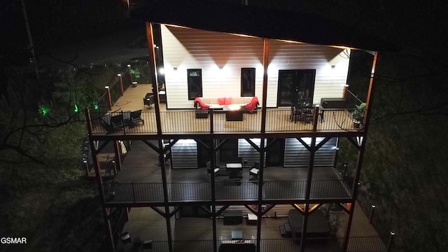 1040 Old Cartertown Rd, Gatlinburg, TN 37738 - back of house at twilight featuring an outdoor hangout area and a balcony