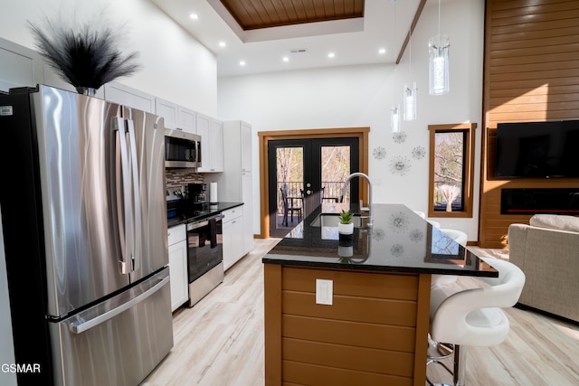 1040 Old Cartertown Rd, Gatlinburg, TN 37738 - kitchen featuring appliances with stainless steel finishes, a towering ceiling, a sink, french doors, and open floor plan