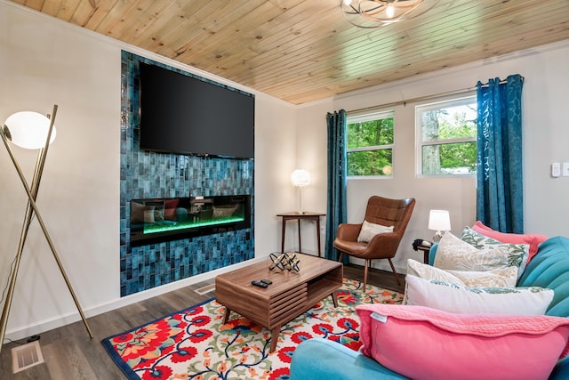 living room with wood finished floors, visible vents, wood ceiling, baseboards, and a tiled fireplace