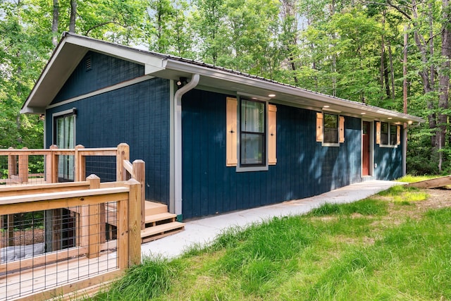 view of side of home with a wooden deck