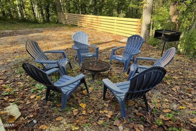 exterior space featuring a fire pit and fence