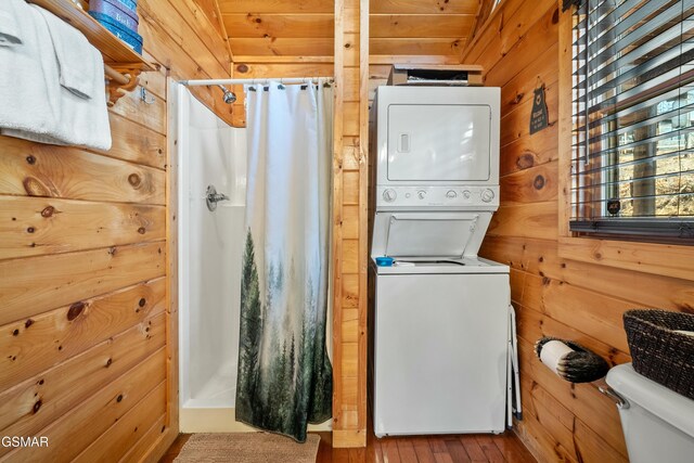 3290 Emerald Springs Loop, Sevierville, TN 37862 - laundry area featuring hardwood / wood-style flooring, wooden walls, and stacked washing maching and dryer