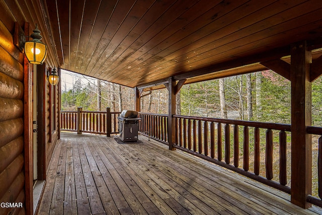 wooden deck featuring a grill