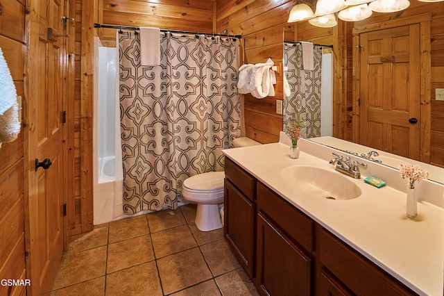bathroom with tile patterned flooring, vanity, toilet, wooden walls, and shower / bath combo with shower curtain