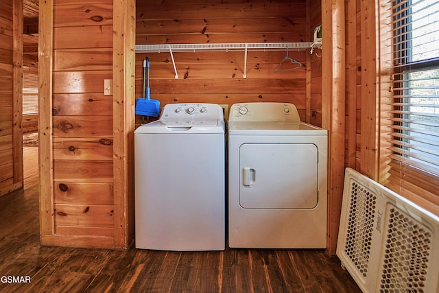 washroom featuring wooden walls, laundry area, dark wood-style flooring, and washer and dryer