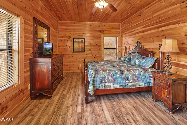 bedroom featuring wooden walls and wood finished floors