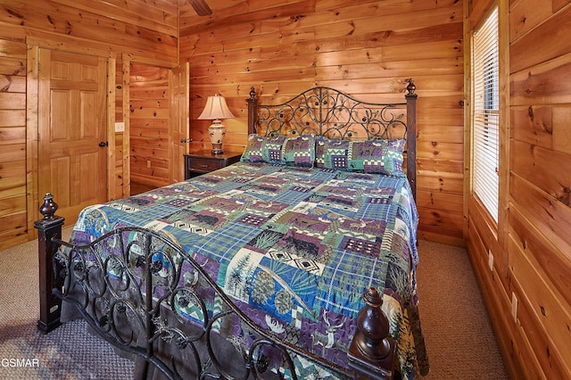 carpeted bedroom with wooden walls