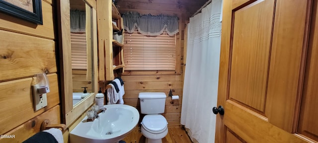 817 Christy Ln, Townsend, TN 37882 - bathroom featuring toilet, a sink, wood finished floors, and wooden walls