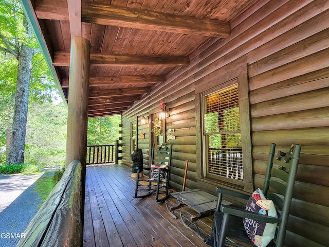 wooden terrace featuring covered porch