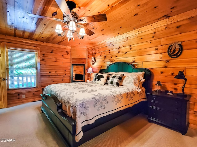 carpeted bedroom featuring wooden walls, ceiling fan, and wooden ceiling