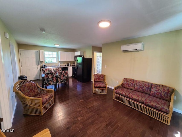 living room featuring baseboards, dark wood-type flooring, and a wall mounted air conditioner