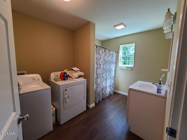 washroom with laundry area, baseboards, dark wood finished floors, separate washer and dryer, and a sink