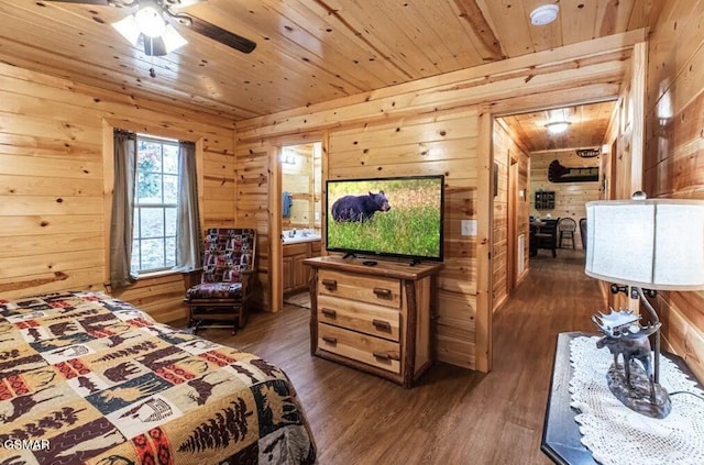 bedroom with wooden walls, dark wood finished floors, and wood ceiling