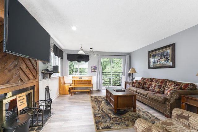 living room featuring a textured ceiling and light wood-type flooring