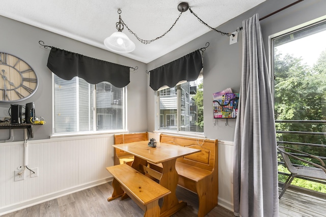 dining area featuring hardwood / wood-style floors and a textured ceiling