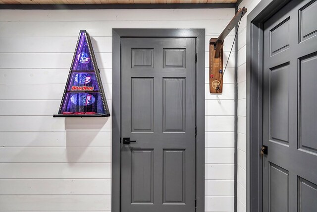 entryway featuring wood walls