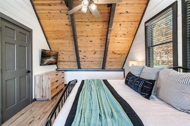 bedroom with hardwood / wood-style floors, lofted ceiling with beams, and wooden ceiling