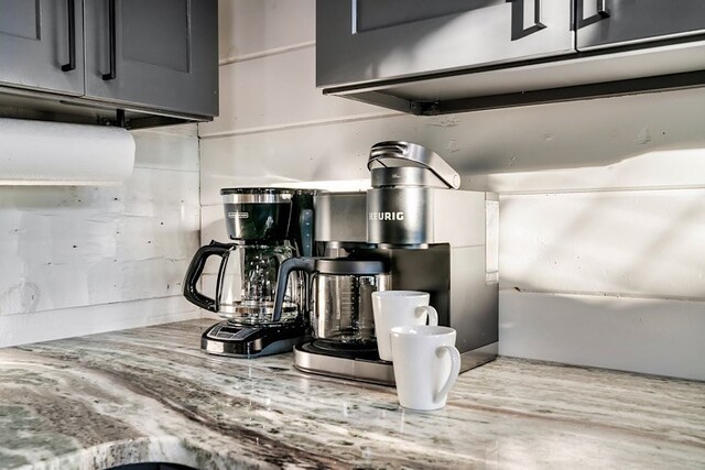 details featuring light stone countertops