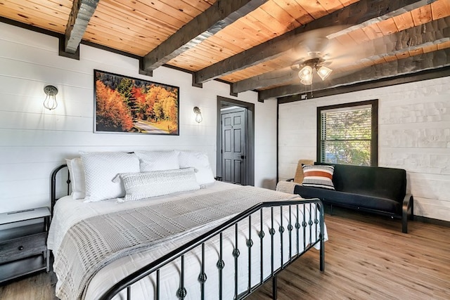 bedroom featuring beamed ceiling, hardwood / wood-style flooring, ceiling fan, and wood ceiling