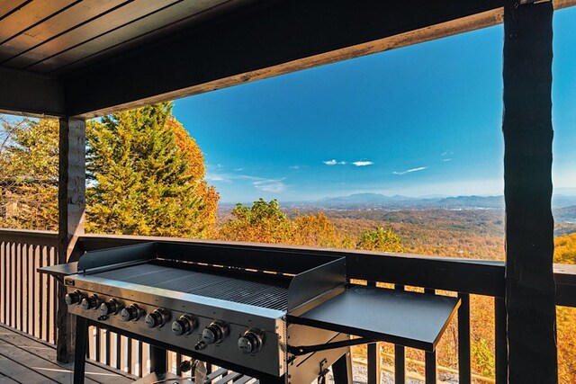 wooden terrace featuring a mountain view and grilling area