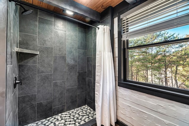 bathroom featuring wood ceiling and walk in shower