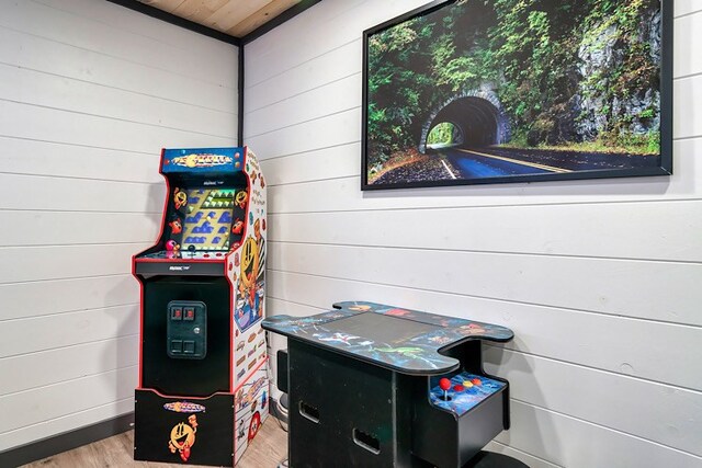 playroom with wood walls and light hardwood / wood-style floors