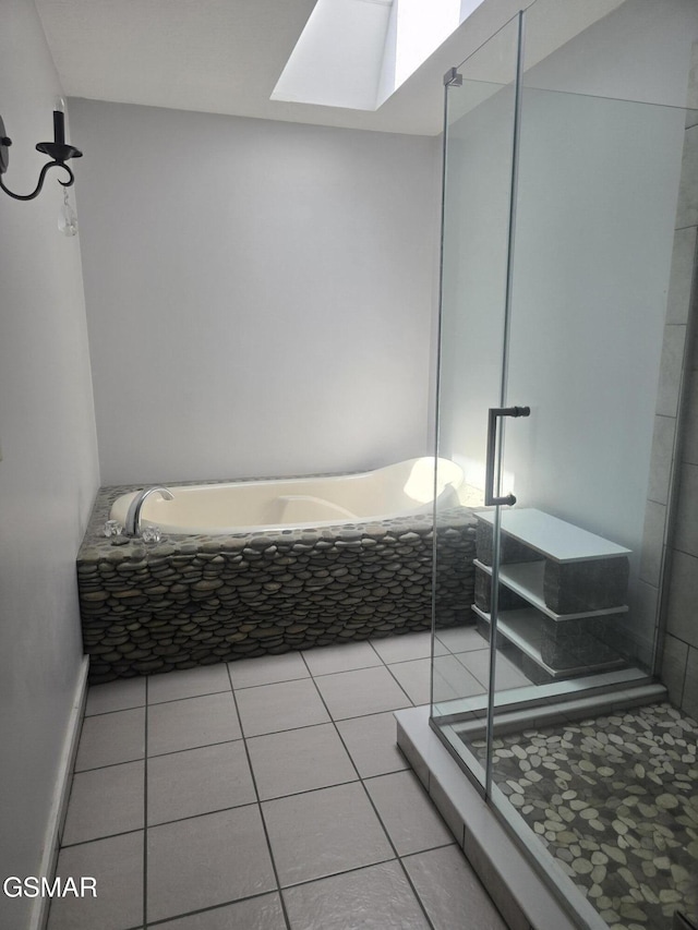 2257 Shinbone Rd, Sevierville, TN 37876 - bathroom with tile patterned flooring, a stall shower, a garden tub, and a skylight