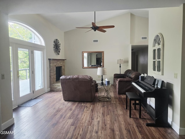 2257 Shinbone Rd, Sevierville, TN 37876 - living area featuring high vaulted ceiling, a stone fireplace, dark wood-style flooring, and a ceiling fan