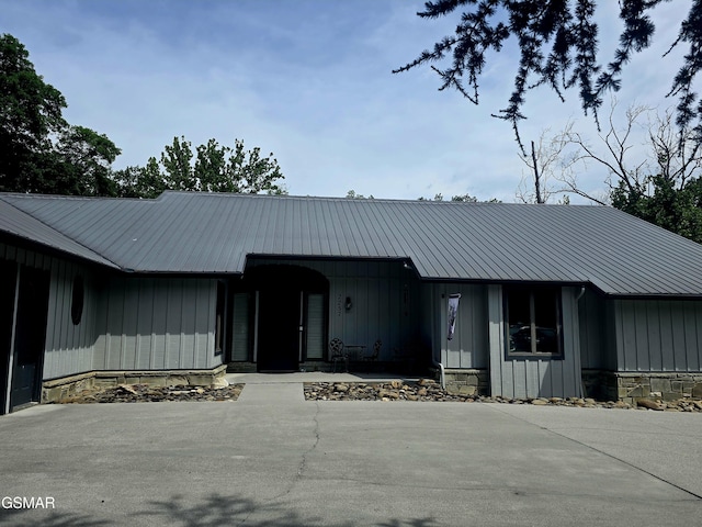 2257 Shinbone Rd, Sevierville, TN 37876 - view of front of home featuring stone siding, a metal roof, and board and batten siding