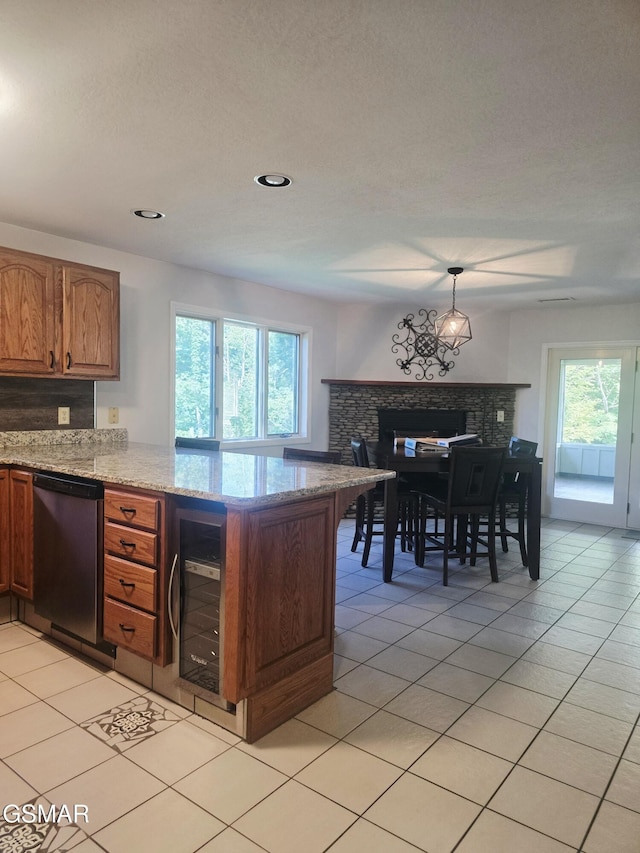 2257 Shinbone Rd, Sevierville, TN 37876 - kitchen featuring dishwashing machine, wine cooler, a peninsula, a fireplace, and healthy amount of natural light