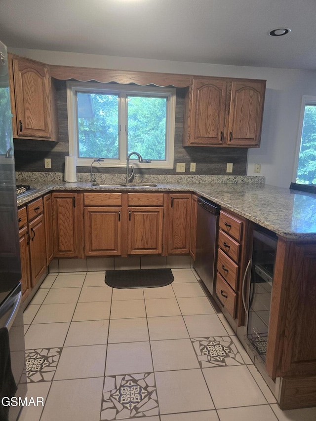 2257 Shinbone Rd, Sevierville, TN 37876 - kitchen with stainless steel dishwasher, a peninsula, beverage cooler, stone countertops, and brown cabinets