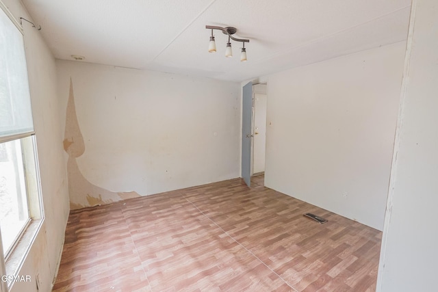 spare room featuring visible vents and light wood-style flooring