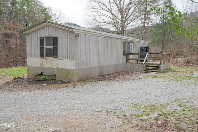 view of side of property featuring a deck