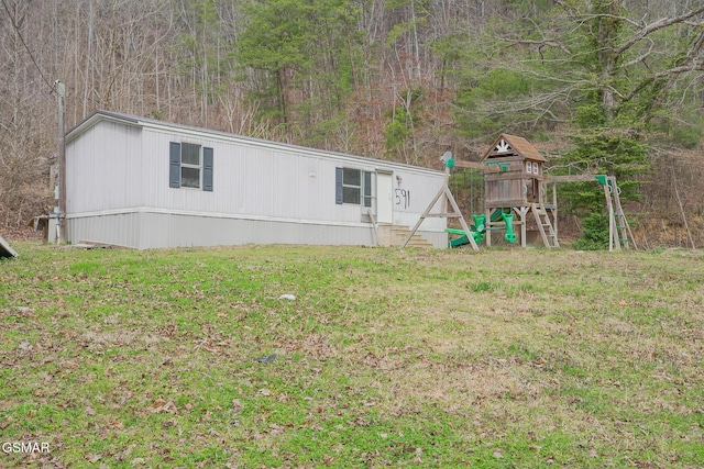 exterior space with a lawn and a playground