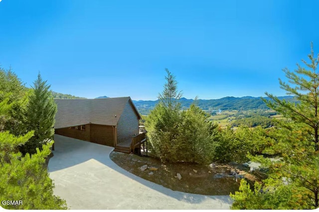 view of property exterior featuring a mountain view