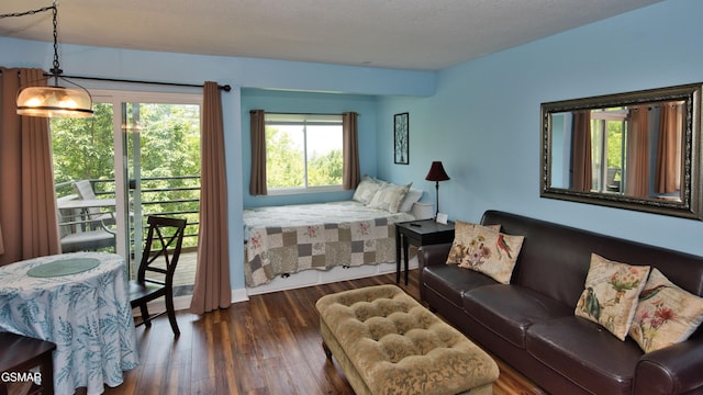 bedroom featuring a textured ceiling and dark hardwood / wood-style flooring