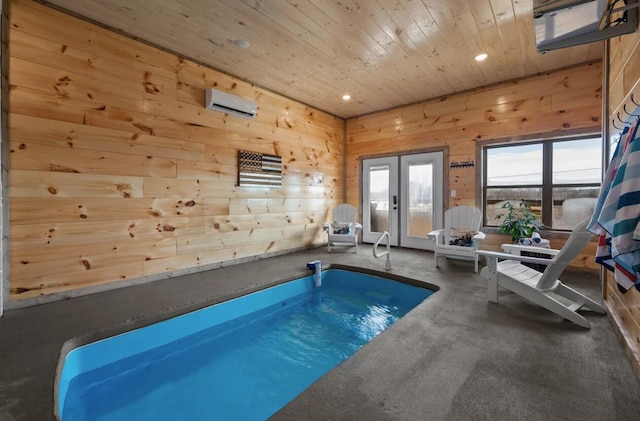 view of swimming pool with an AC wall unit, a jacuzzi, and french doors