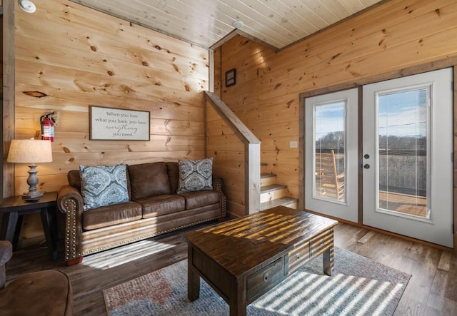 living area featuring wood ceiling, wooden walls, and wood finished floors