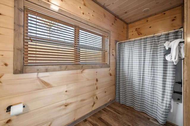 full bath with shower / tub combo, wood finished floors, wood walls, and wooden ceiling