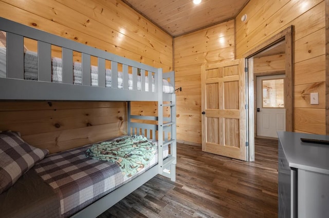 bedroom with wooden walls, wood finished floors, and wooden ceiling