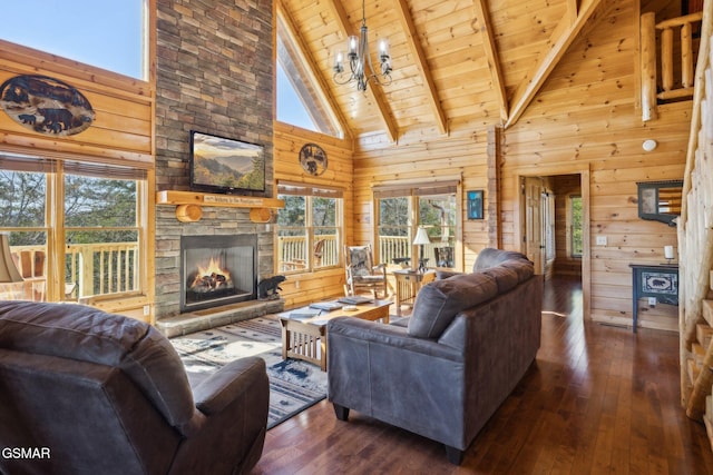 living room featuring wood walls, wood ceiling, hardwood / wood-style flooring, and a stone fireplace