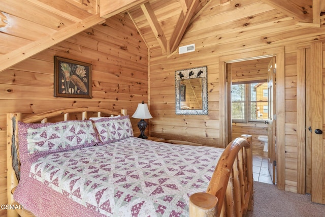 bedroom with vaulted ceiling with beams, visible vents, wood walls, wooden ceiling, and tile patterned floors